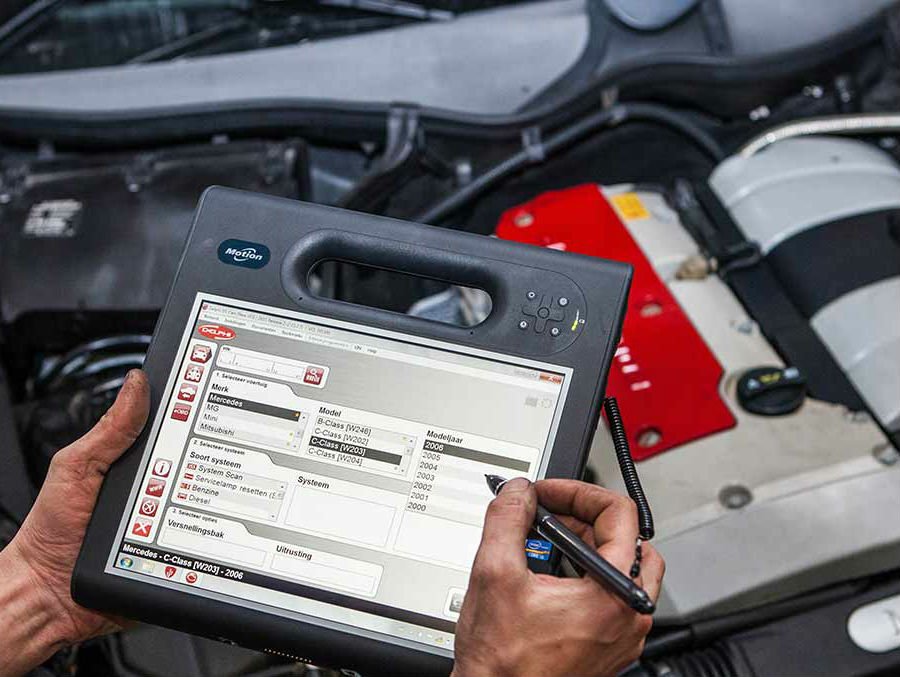 Photo of an automotive diagnostic tool in an engine compartment being used by a mobile auto repair technician in Huntington Beach.